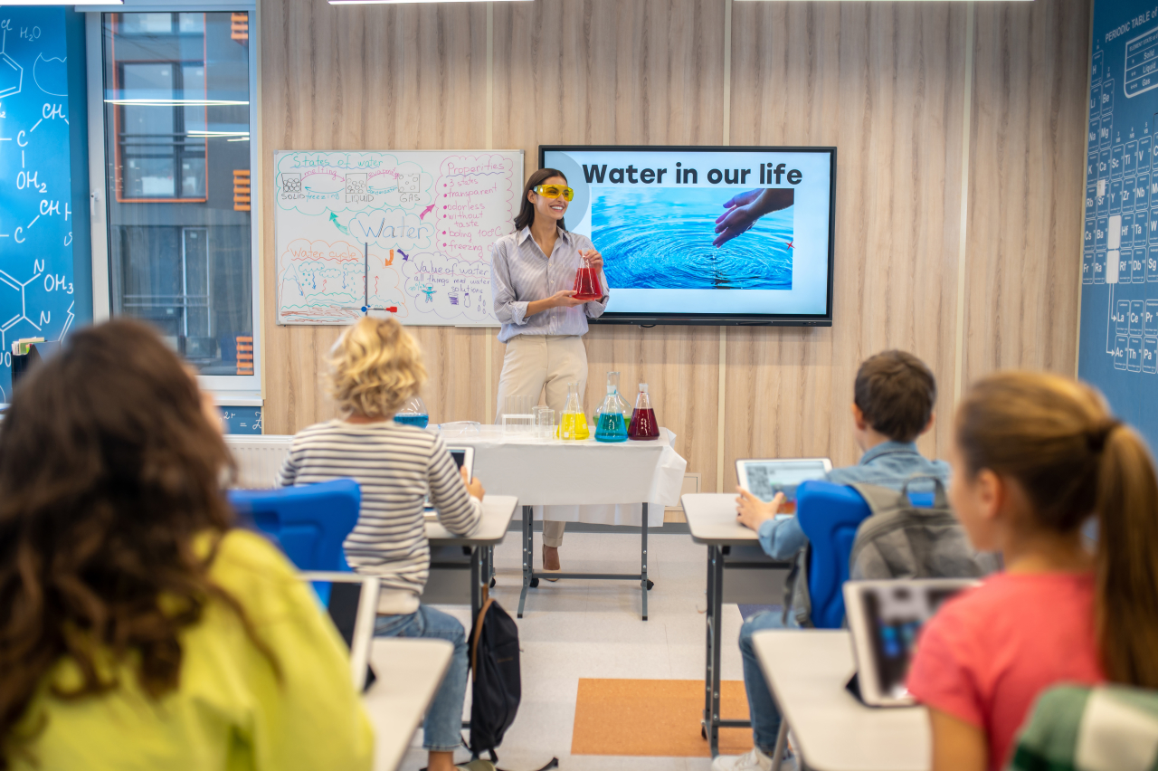 Teacher using an interactive smart board during a science demonstration